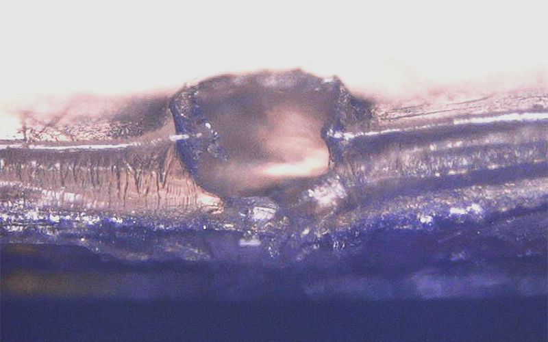 A cross-sectional image of an impact crater on Bay 5 multi-layer insulation. Credit: NASA ODPO.