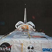 Orbital Debris Radar Calibration Spheres (ODERACS) experiment. ODERACS deployed spheres 
									and dipoles from the Shuttle to calibrate the Haystack orbital debris radar measurements. An 
									ODERACS sphere being deployed is visible just over the Shuttle's tailfin. Credit: NASA.