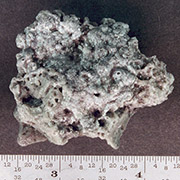 Solid rocket motor (SRM) slag. Aluminum oxide slag is a byproduct of SRMs. Orbital 
									SRMs used to boost satellites into higher orbits are potentially a significant source of centimeter 
									sized orbital debris. This piece was recovered from a test firing of a Shuttle solid rocket booster. 
									Credit: NASA.