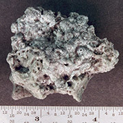 Solid rocket motor (SRM) slag. Aluminum oxide slag is a byproduct of SRMs. Orbital 
									SRMs used to boost satellites into higher orbits are potentially a significant source of centimeter 
									sized orbital debris. This piece was recovered from a test firing of a Shuttle solid rocket booster. 
									Credit: NASA.