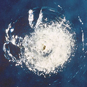 Window pit from orbital debris on STS-007. Credit: NASA.